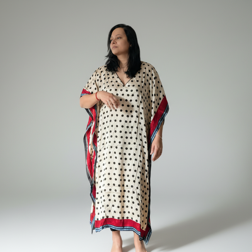 Woman wearing a polka dot dress with red and blue accents on a white background